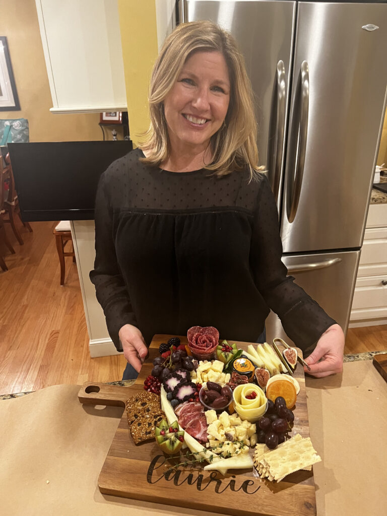 A private class participant, standing in the kitchen of the host's home, showing off their work