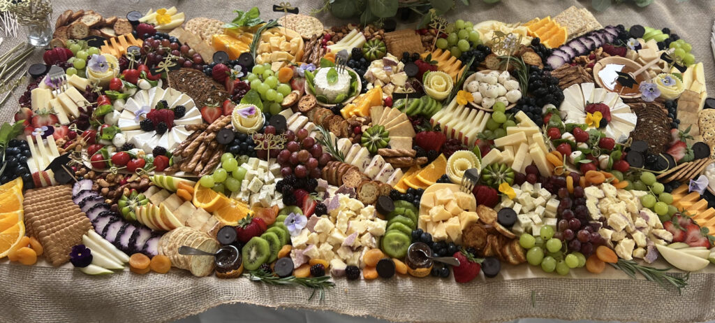 The top view of a large Grazing Table arranged by hand to celebrate a new Class of 2023 Graduate